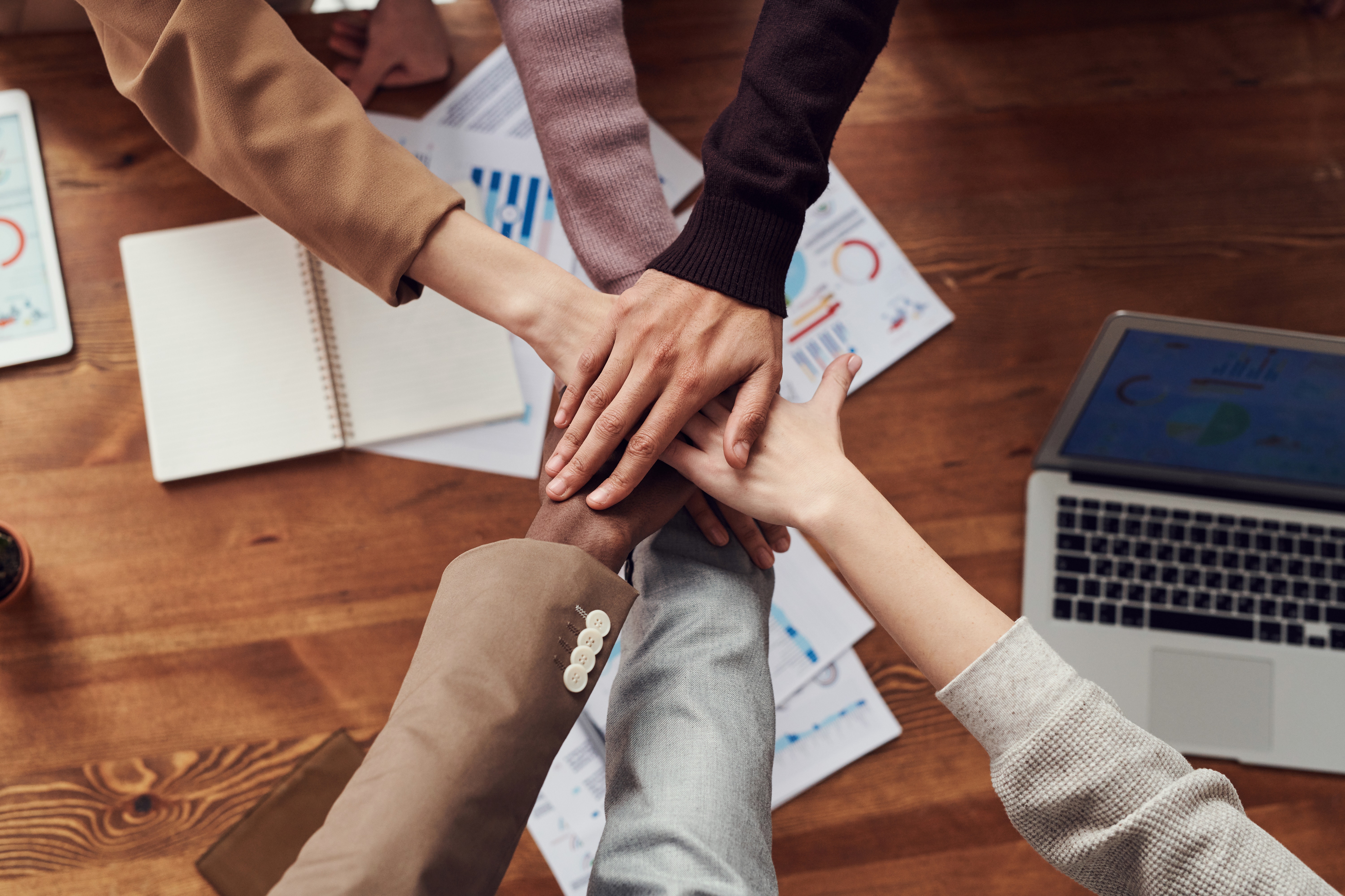 Image of a teams hands together showing trust